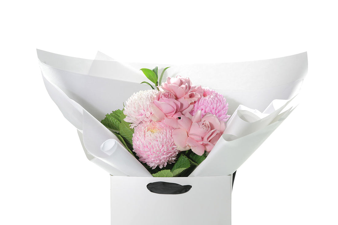 Kate Hill Flowers – small blush pink birthday posy with roses, disbuds and foliage hand-tied.