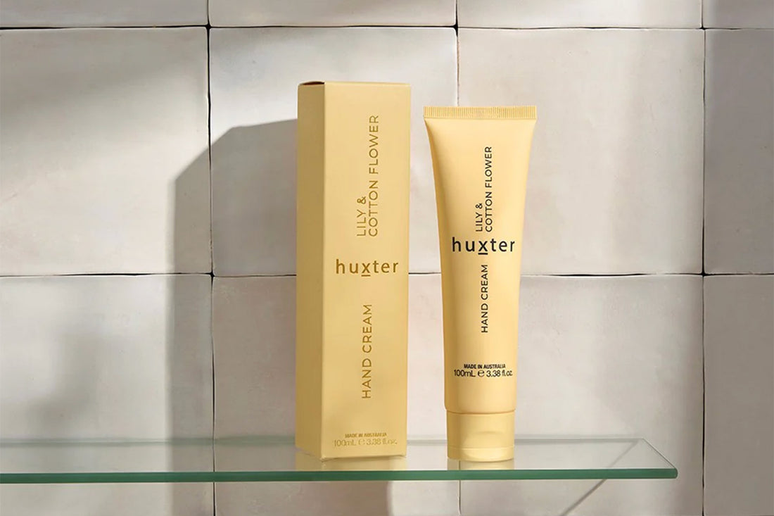 Huster hand cream and packaging in bathroom setting