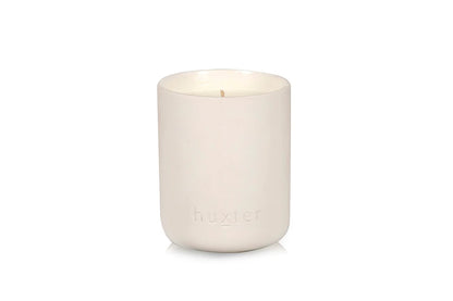 White candle in a ceramic holder with &