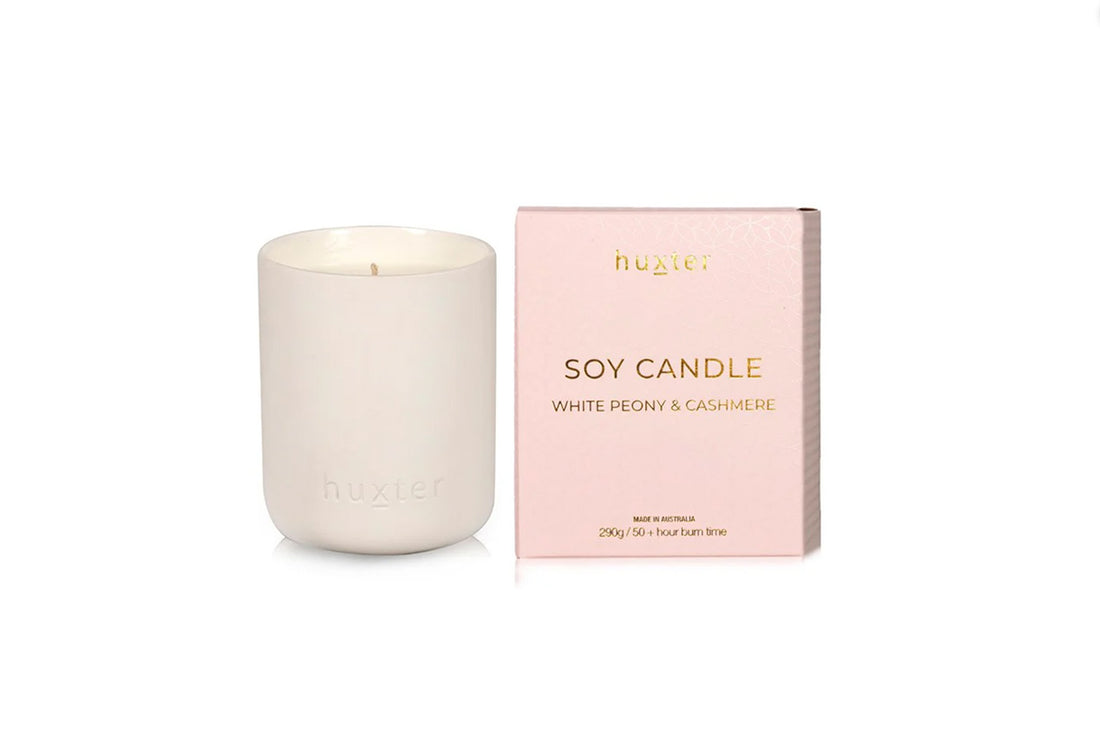 White Huxster soy candle with pink packaging on a white background