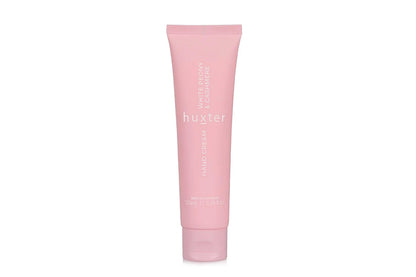 Pink tube of Huxster hand cream on a white background