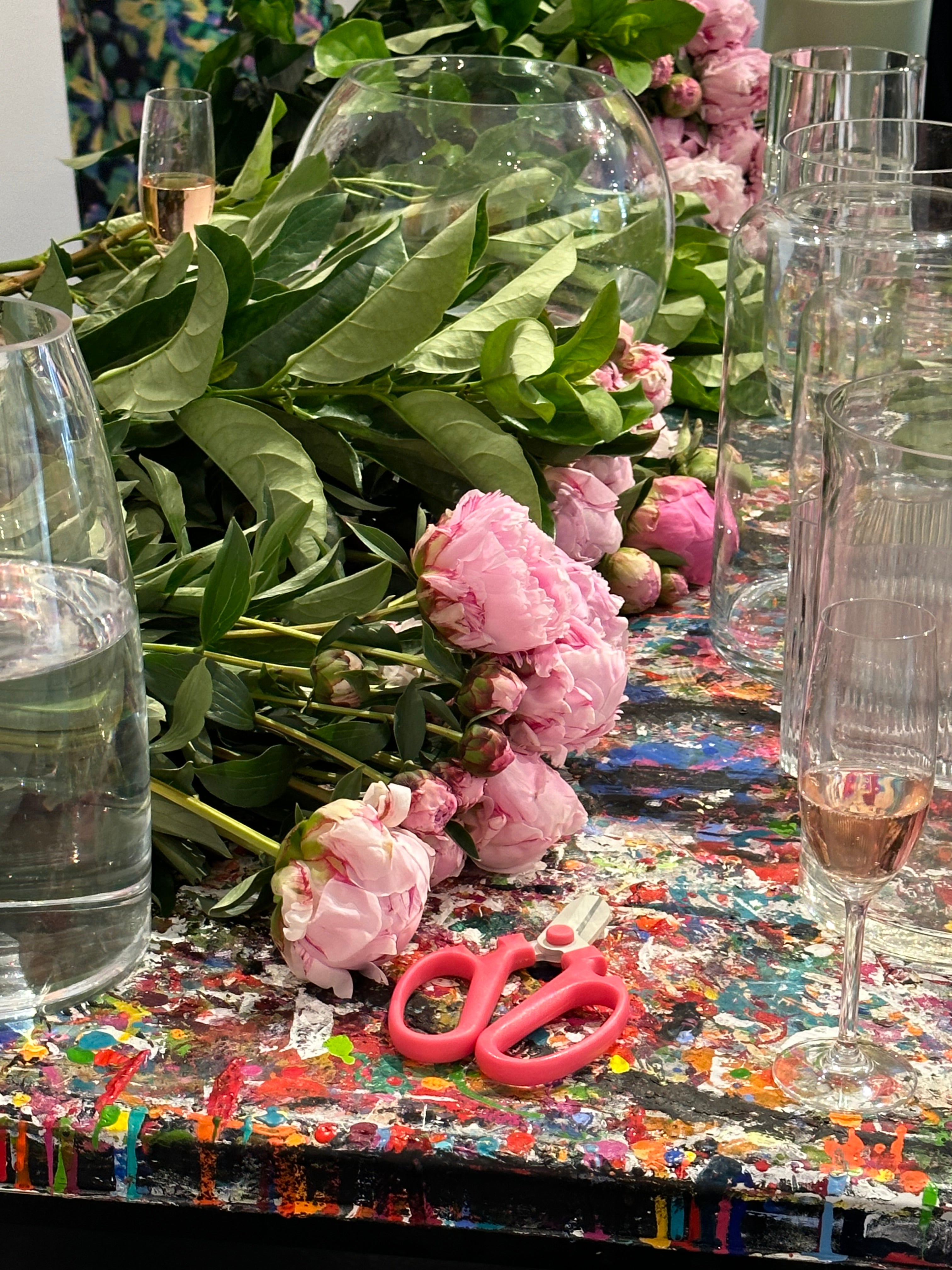 Kate Hill hosting a Peony Rose flower workshop, surrounded by Peony Roses, vases and Plume art work.