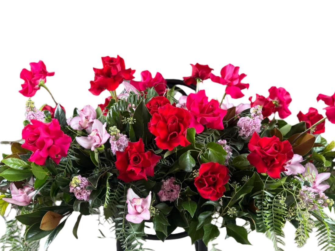 A close up of hot pink and pale pink casket funeral spray.