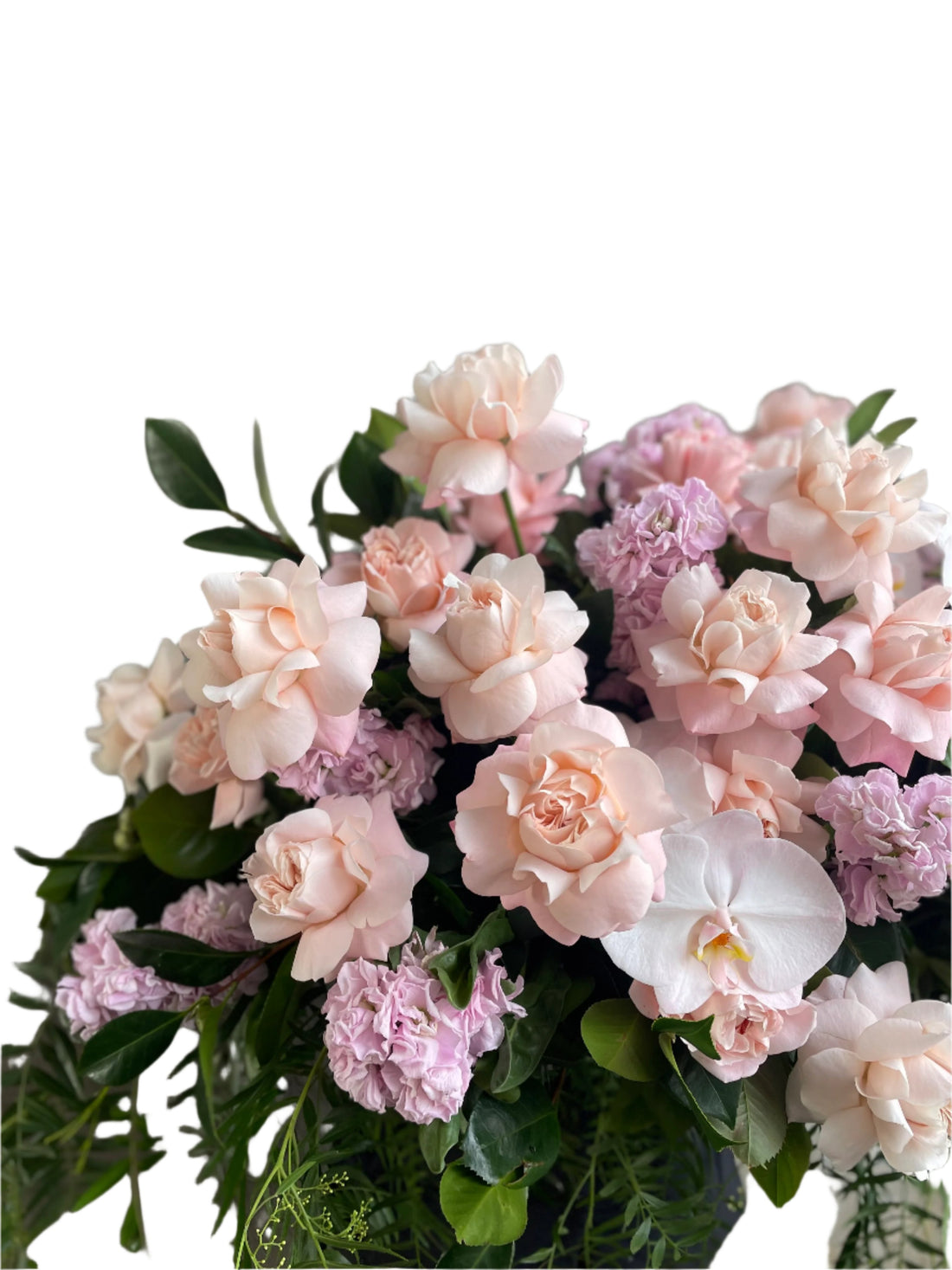 Close up image of Pastel pink, white and green casket design, held by a florist wearing back, up against a white wall.