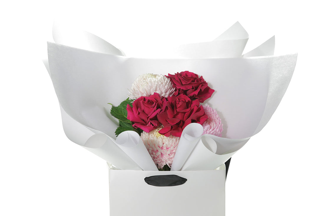 Kate Hill Flowers – small blush and hot-pink birthday posy with Floyd roses, hydrangeas and foliage hand-tied.