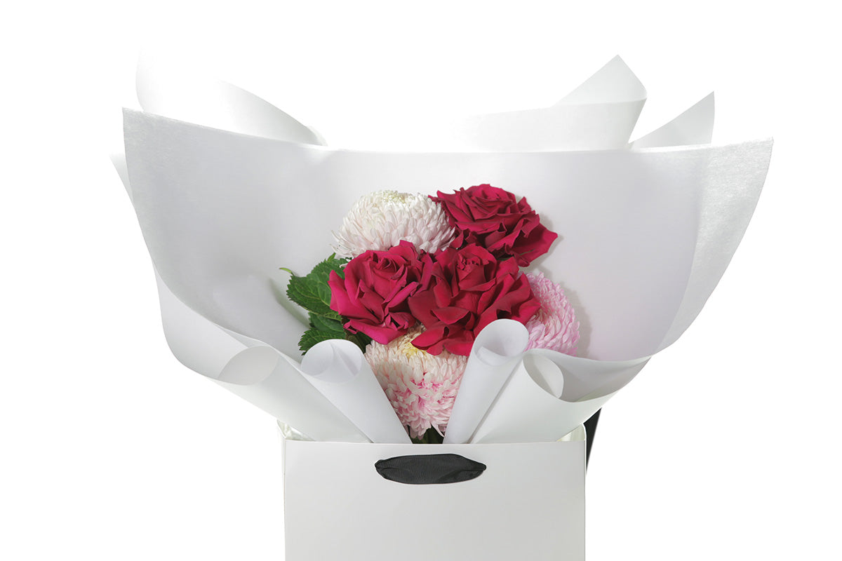 Kate Hill Flowers – small blush and hot-pink birthday posy with Floyd roses, hydrangeas and foliage hand-tied.