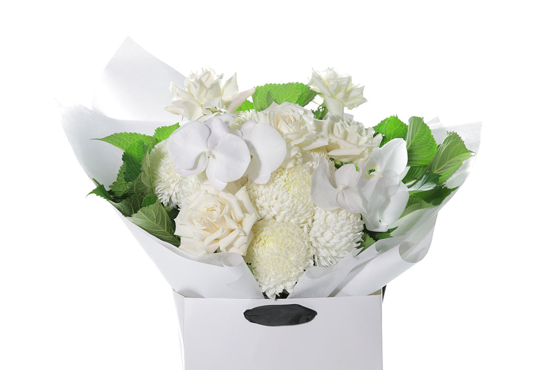 Kate Hill Flowers – large white sympathy bouquet of roses, chrysanthemums and greenery hand-tied.