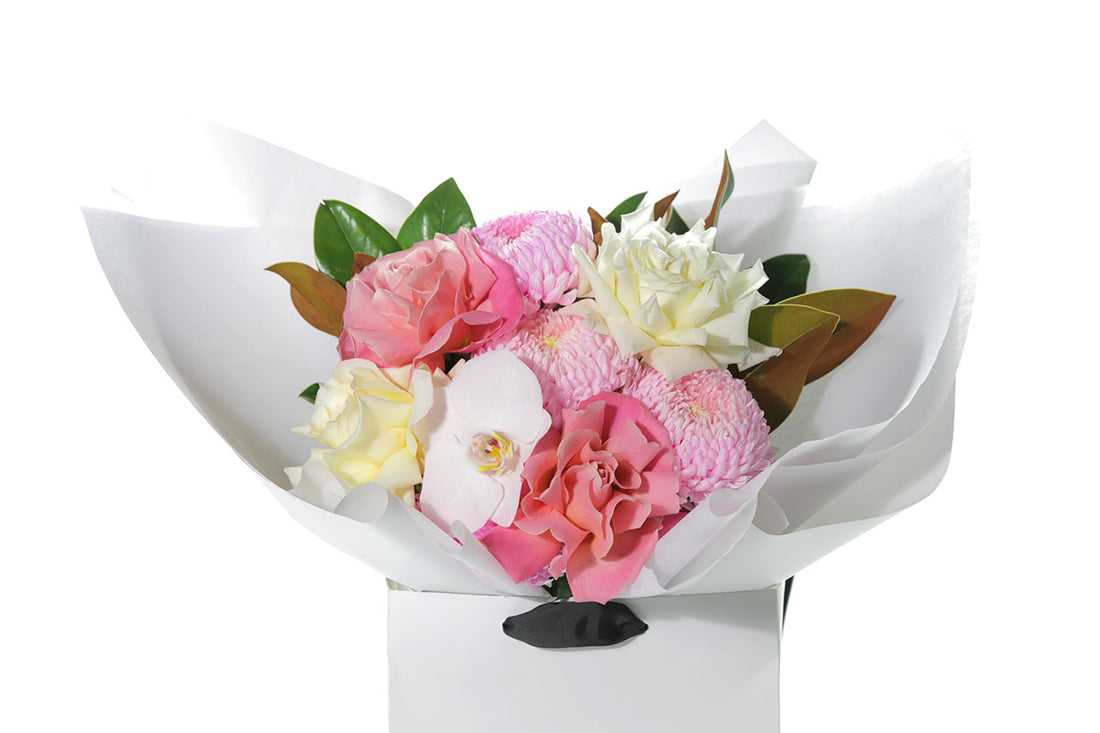 Kate Hill Flowers – medium mixed-pastel birthday bouquet of roses, chrysanthemums, orchids and foliage, hand-tied.