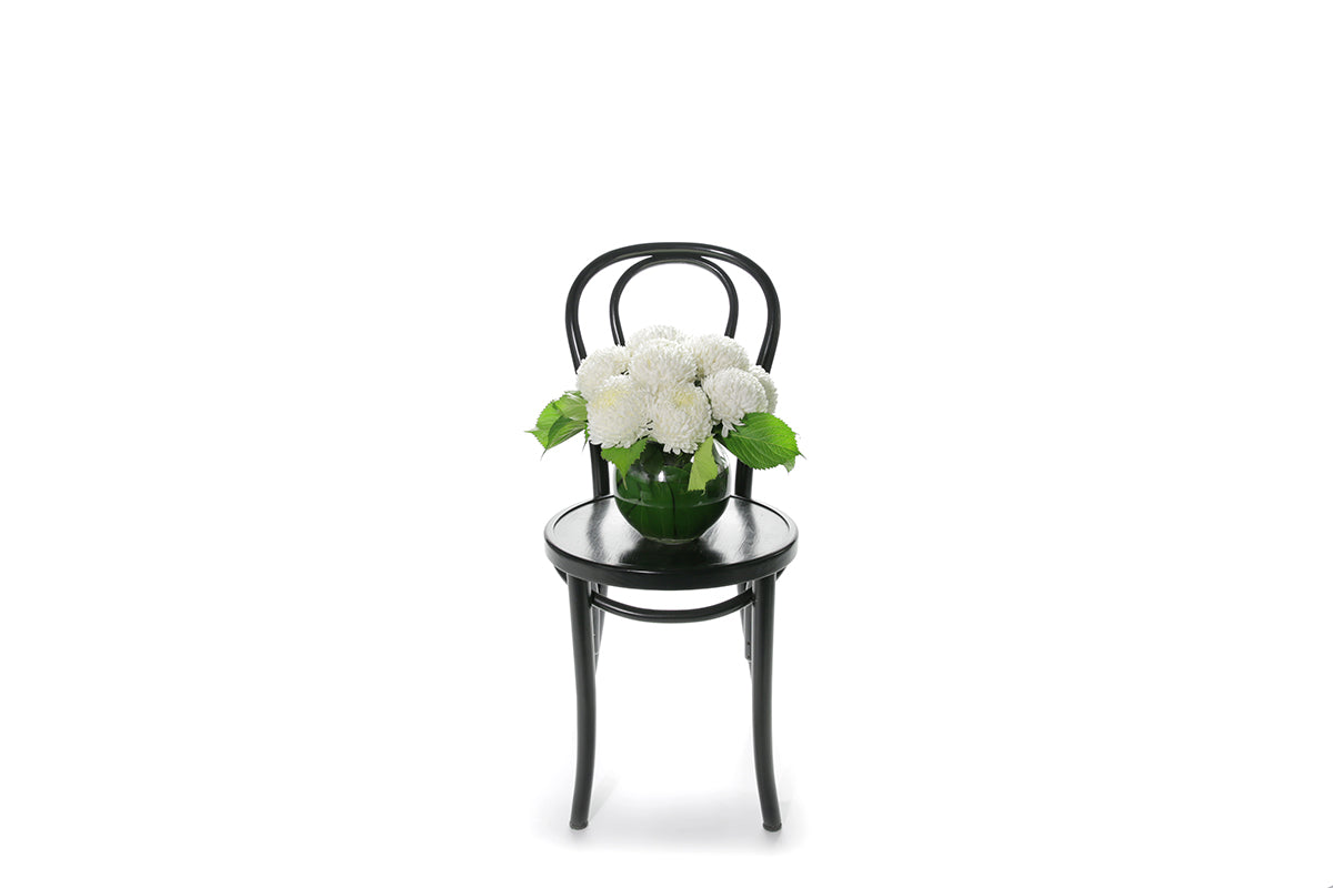 Kate Hill Flowers – white chrysanthemum sympathy ball-vase design with monstera leaf lining.