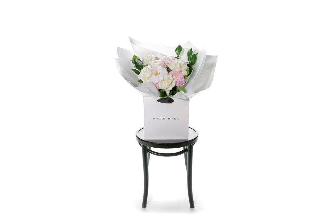 Kate Hill Flowers – medium white sympathy bouquet of roses, chrysanthemums and greenery, hand-tied.