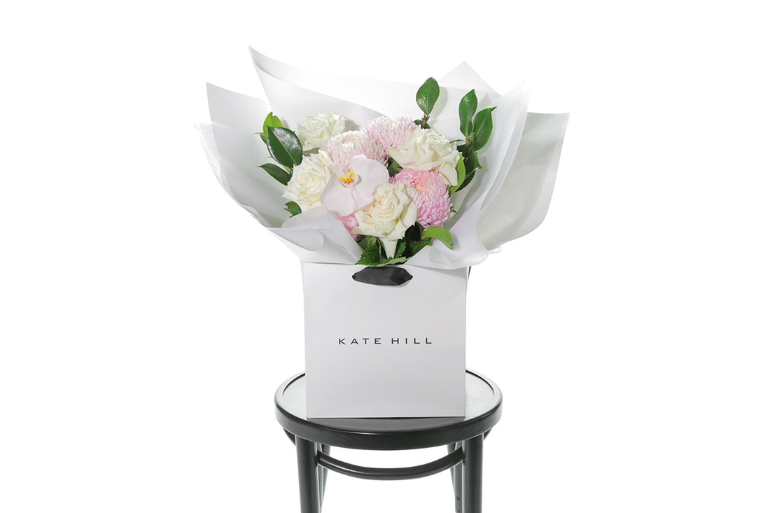 Kate Hill Flowers – medium white sympathy bouquet of roses, chrysanthemums and greenery, hand-tied.
