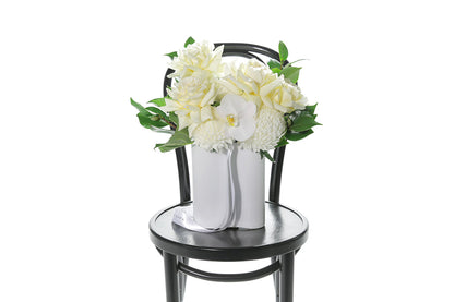 Kate Hill Flowers – white and lemon congratulations vase with roses, chrysanthemums, orchids and foliage in a white wave ceramic.