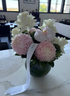Floral arrangement with pink and white flowers on a marble table