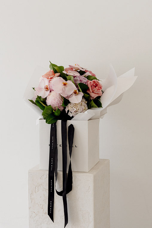 Bouquet of flowers in a box with a black ribbon on a white background ready for same day delivery in Melbourne
