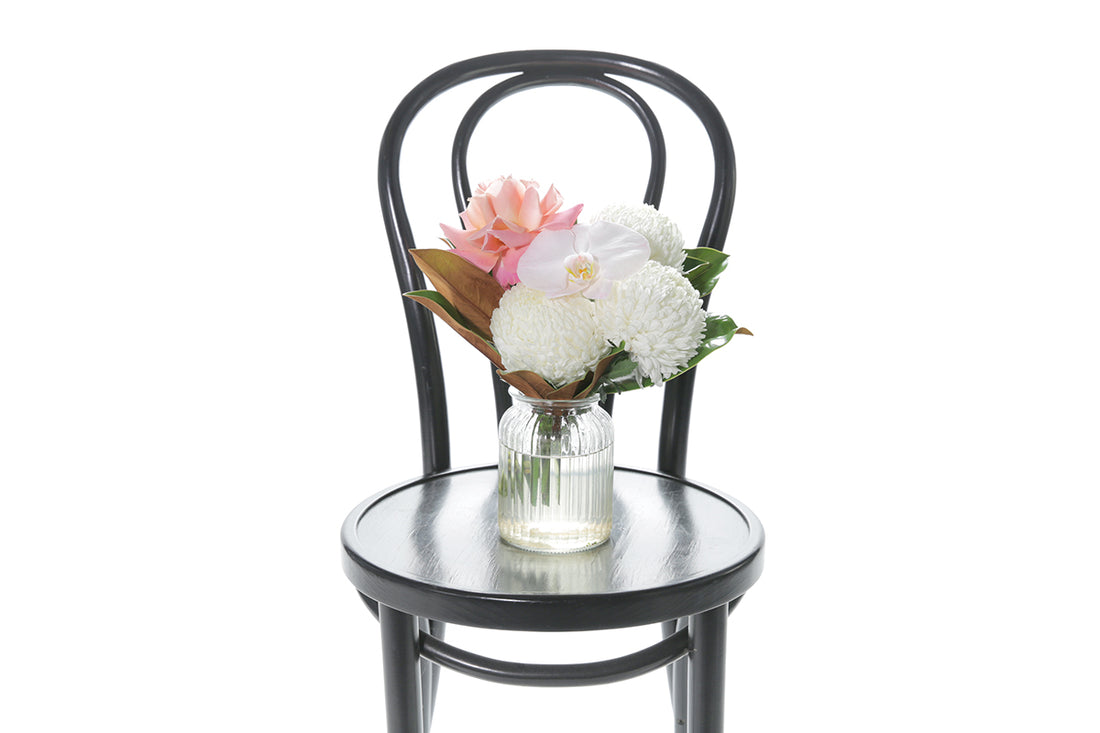 Kate Hill Flowers – small ribbed jar vase with blush orchid, white disbud, pink rose and magnolia foliage.