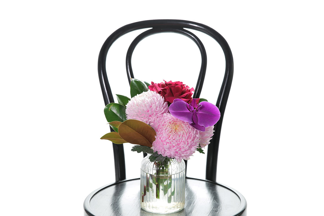 Kate Hill Flowers – small ribbed jar with pink chrysanthemum, hot-pink rose or orchid bloom, ready for birthday gifting.