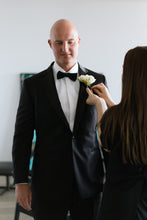 Kate Hill pinning Groom with white freesia buttonhole.