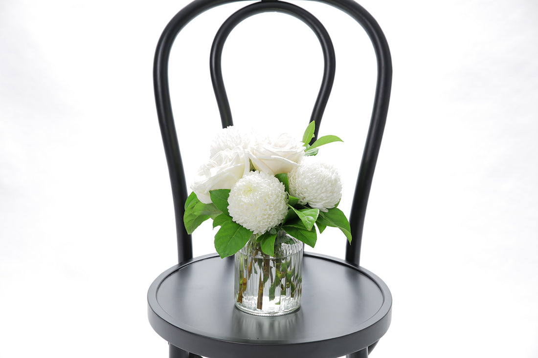 Close-up of BAILEY ribbed vase with white disbuds and roses