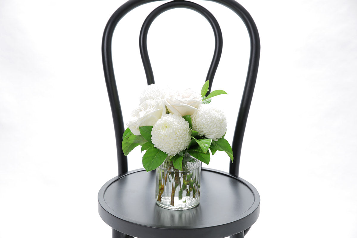 Close-up of BAILEY ribbed vase with white disbuds and roses