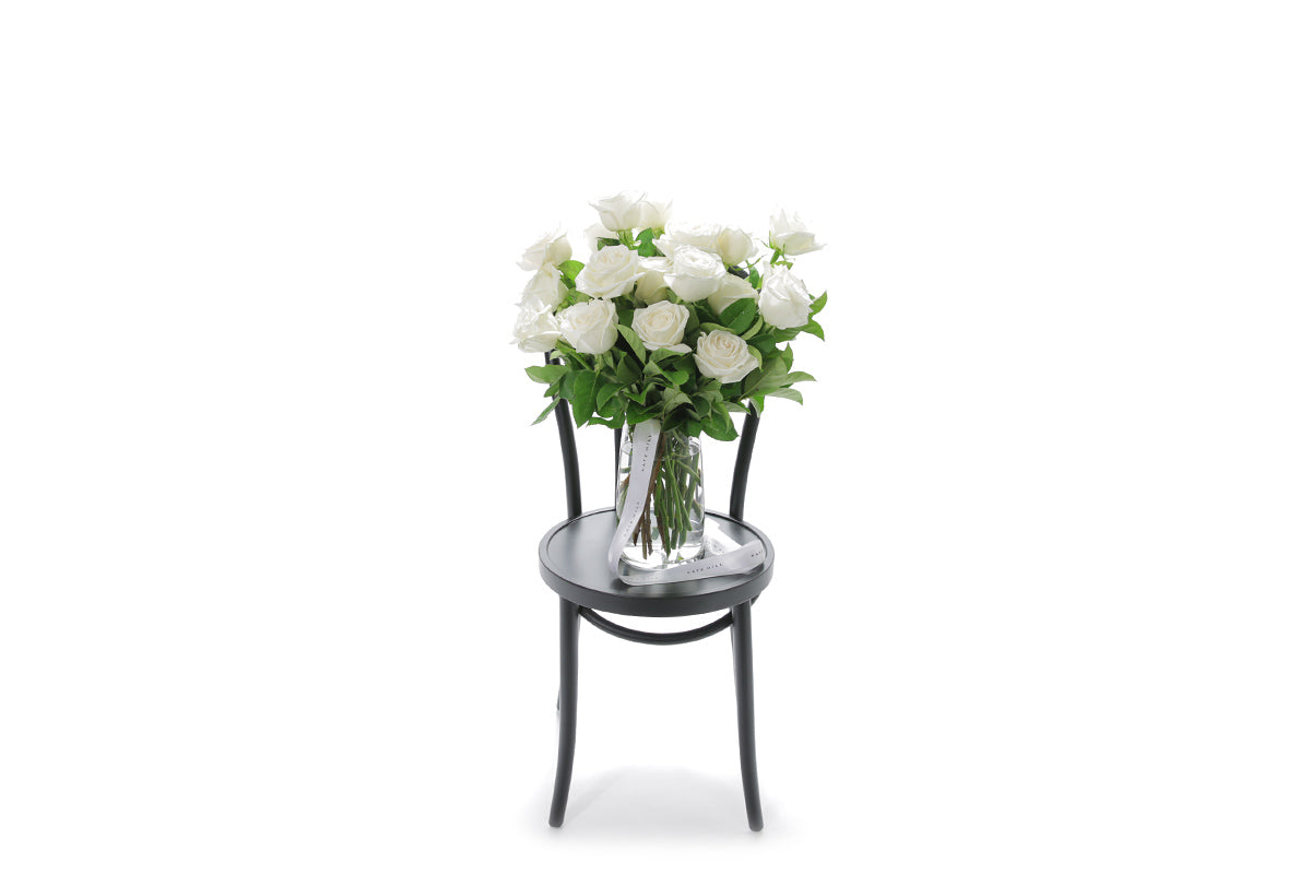 BLANCA 20 white roses in a tapered glass vase lined with monsteria