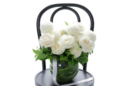 Close-up of ELISE large ball vase with white disbuds and roses
