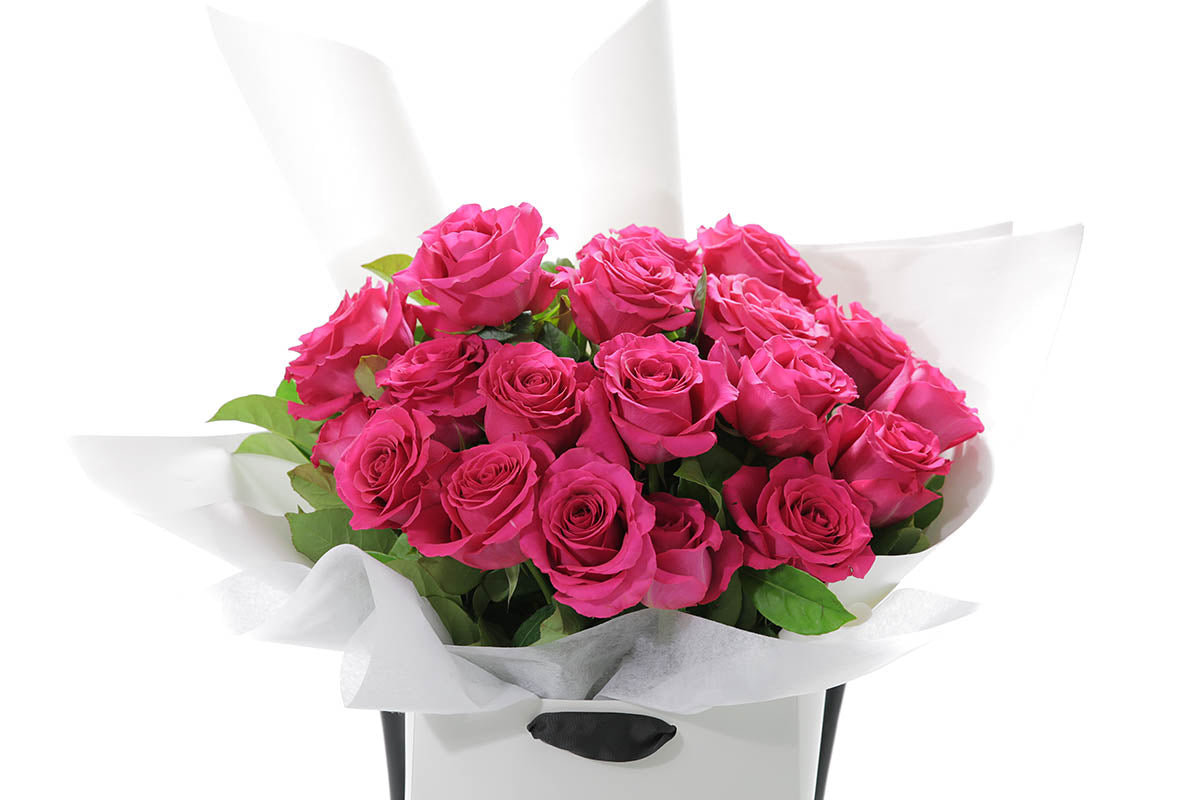 Close-up of FLOYD large bouquet with hot pink classic roses