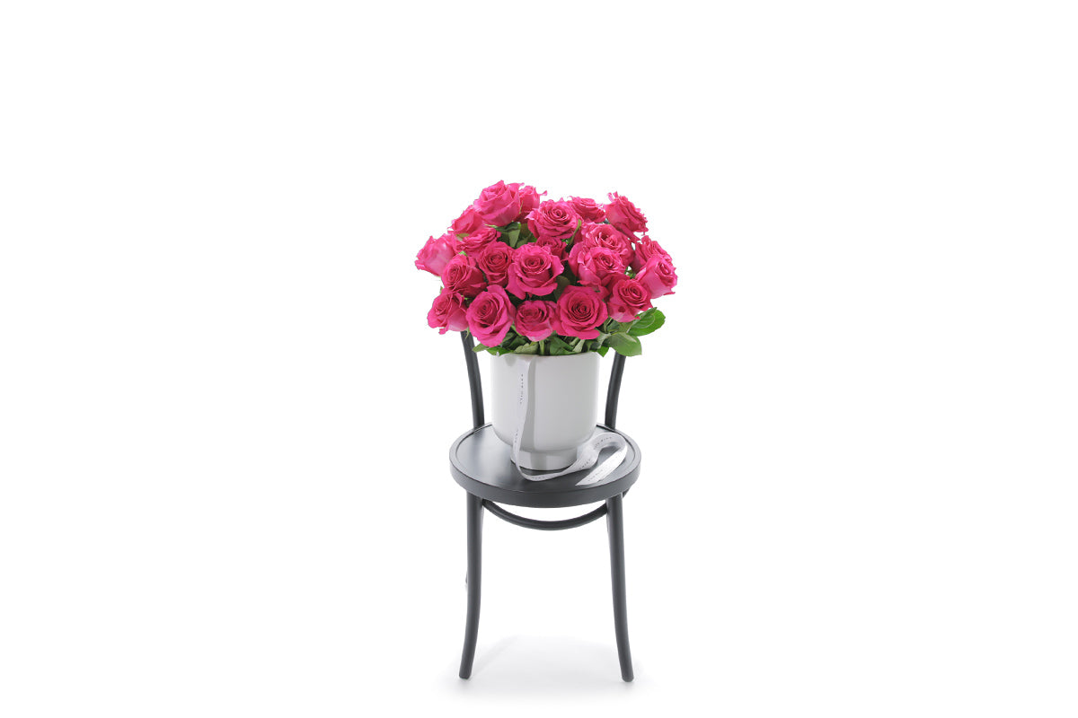 FLOYD 20 hot pink roses in an extra large white footed ceramic vessel