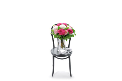 HALEY mixed-colour roses in a tapered glass vase lined with monsteria