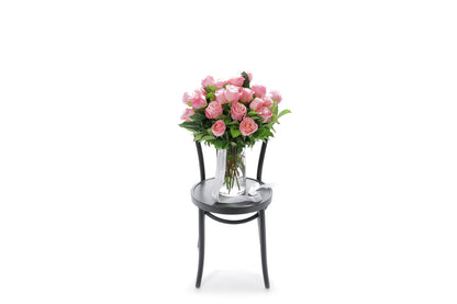 HERMOSA 20 watermelon roses in a tapered glass vase lined with monsteria