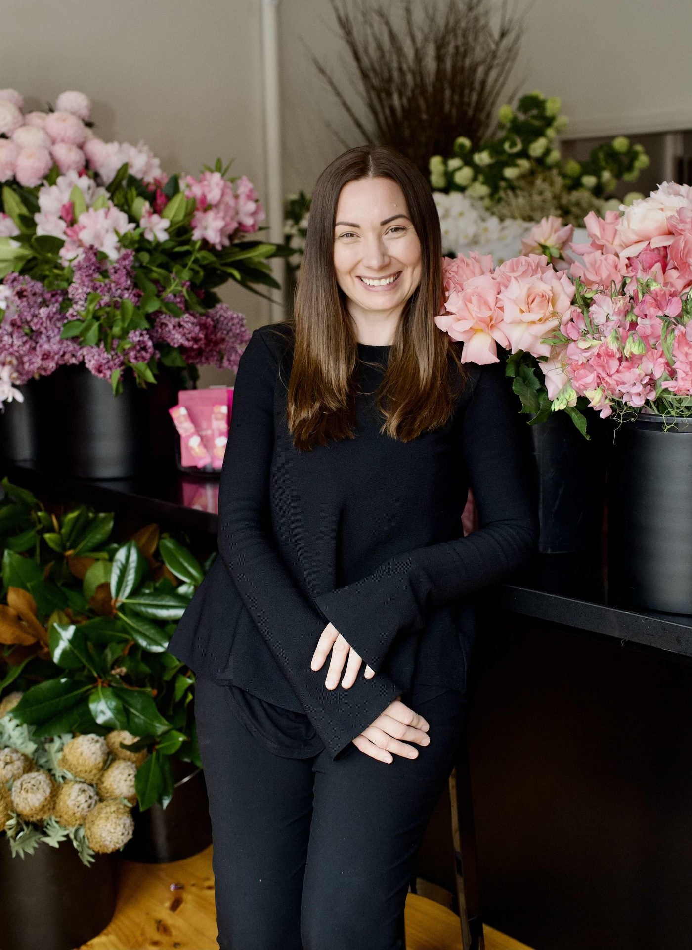 Melbourne florist Kate Hill in her studio surrounded by seasonal flowers
