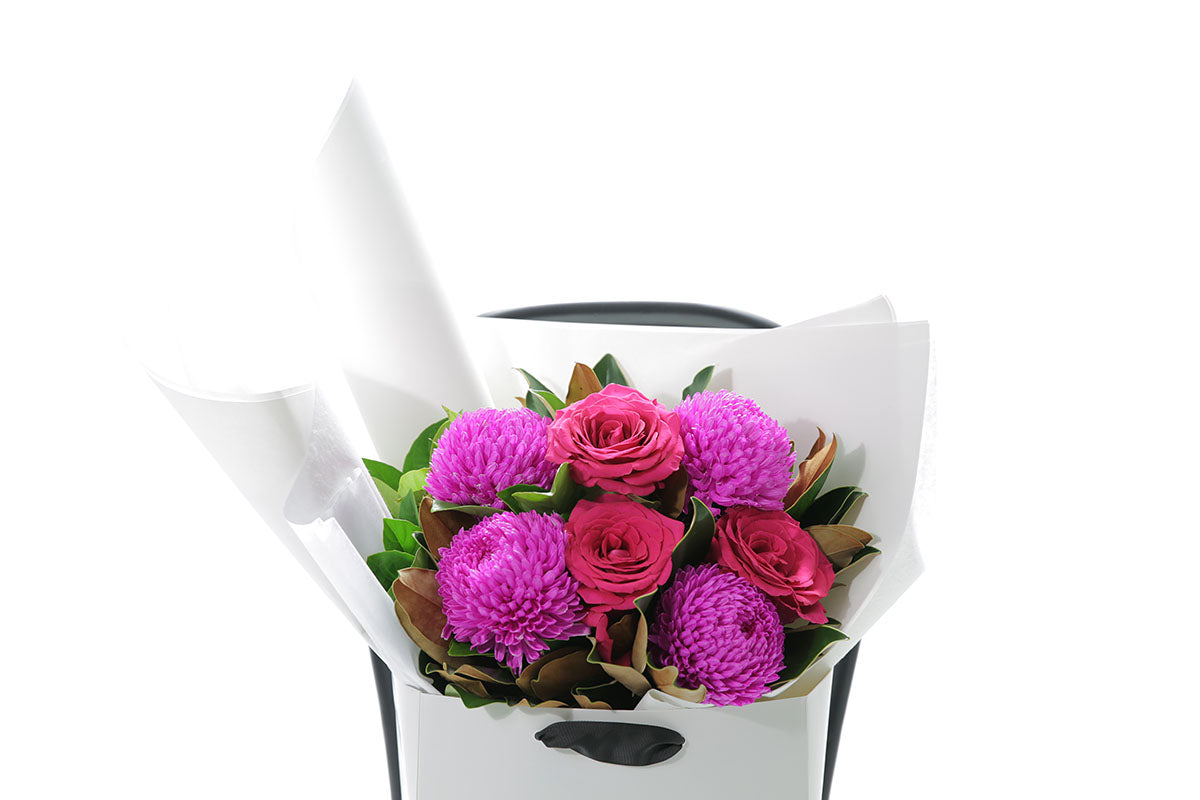 Close-up of LENI large bouquet with hot pink and magenta seasonal blooms