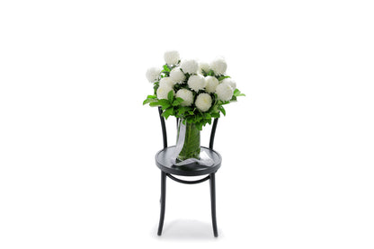 PIPER white disbuds in a tapered glass vase lined with monsteria