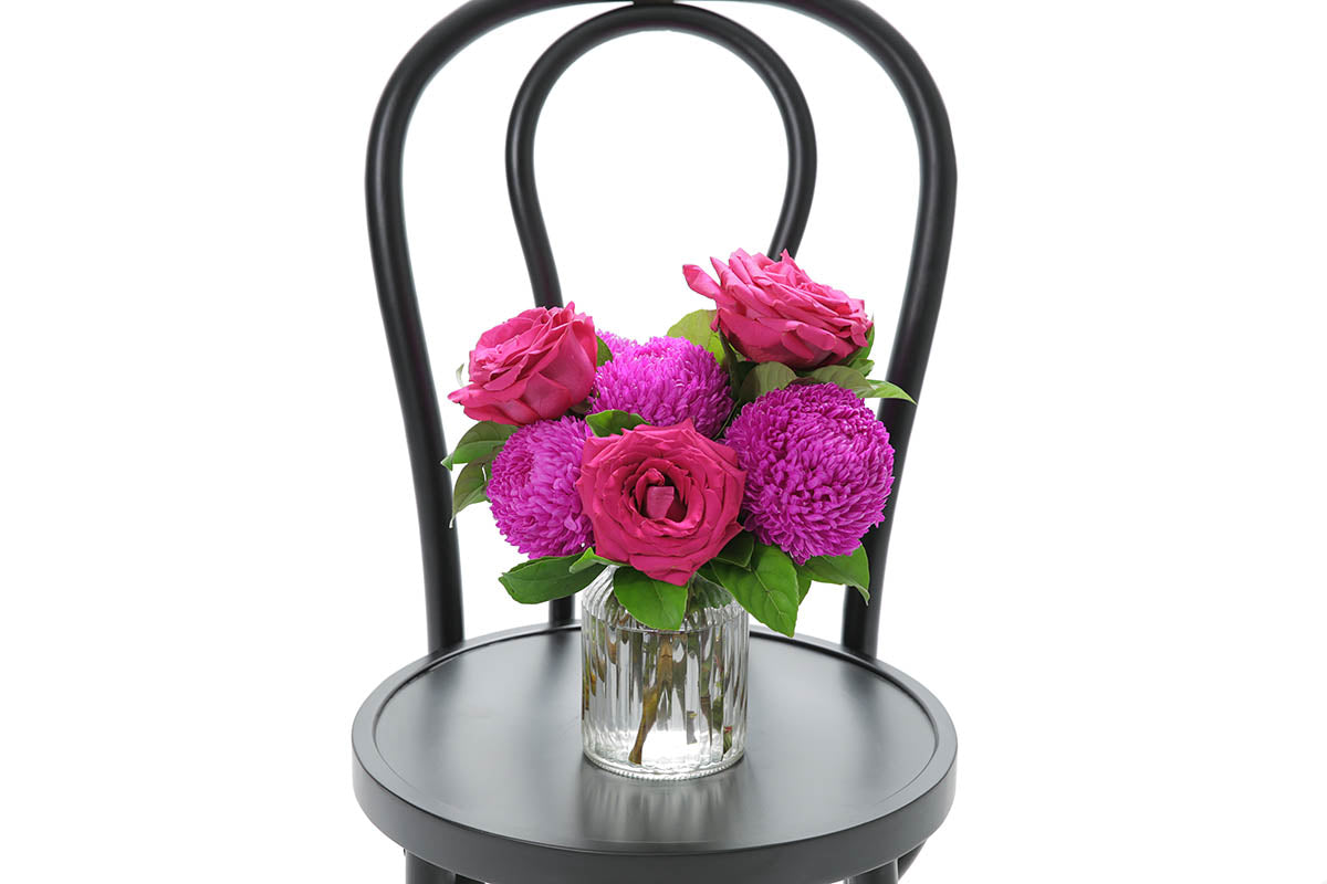 Close-up of ROYCE ribbed vase with hot pink disbuds and roses