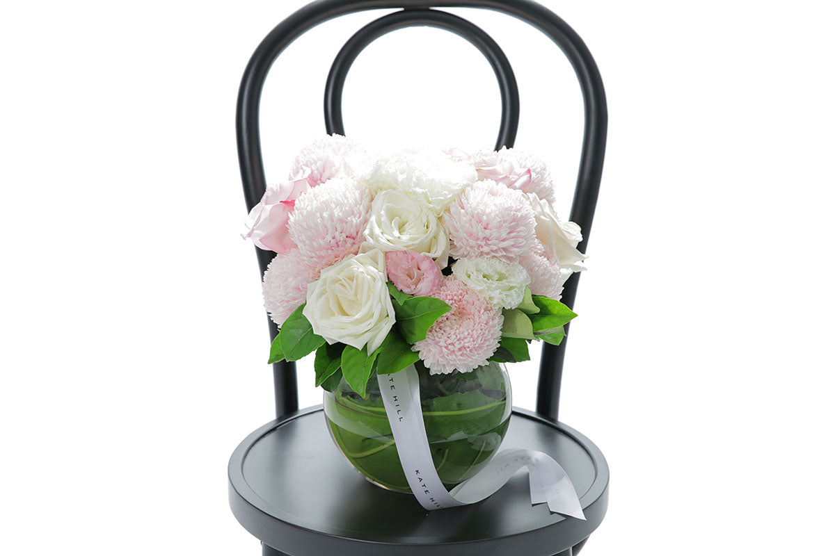 Close-up of SERENITY large ball vase with blush and white disbuds and roses