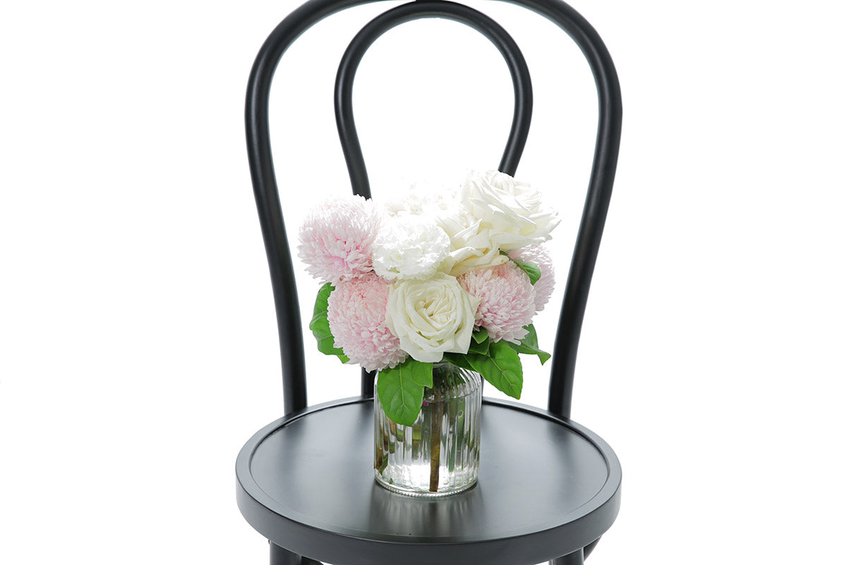 Close-up of SERENITY large ribbed vase with blush and white disbuds and roses