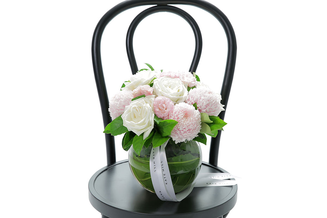 Close-up of SERENITY ball vase with blush and white disbuds and roses