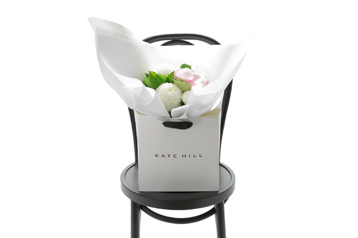 SERENITY Floral arrangement in a white box on a black chair with &