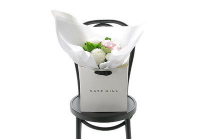 SERENITY Floral arrangement in a white box on a black chair with &