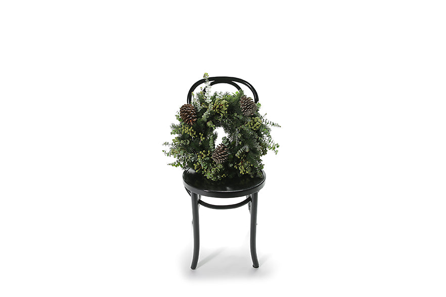 Wide image of the wreath sitting on a black bentwood chair to give you an honest idea of the size. Fragrant and festive wreath sitting on a black bentwood chair. Presenting our ASPEN Medium 45cm Wreath – an embodiment of the season&